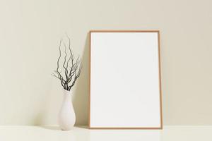 minimalistische en schone verticale houten poster of fotolijstmodel op de vloer, leunend tegen de kamermuur met vaas foto