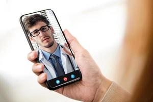 patiënt die online videogesprek voert met arts via mobiele telefoon, medische thuisconsultatie en telemedische concepten foto