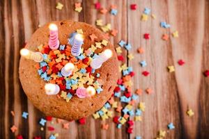 feestelijke cupcake, bestrooid met versieringen, met brandende kaarsen, foto
