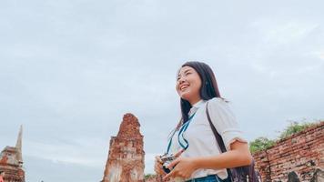 reiziger aziatische vrouw die vakantiereis doorbrengt in ayutthaya, thailand, japanse backpacker vrouw geniet van haar reis bij een geweldig oriëntatiepunt in de traditionele stad. levensstijl vrouwen reizen vakantie concept. foto
