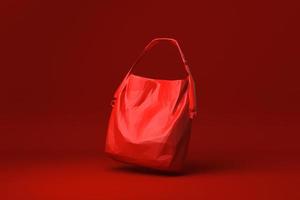 rode tas damesmodeaccessoires drijvend op rode achtergrond. minimaal concept idee creatief. origami-stijl. 3D render. foto