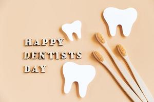 internationale tandartsdag. milieuvriendelijke houten tandenborstels op beige achtergrond. foto