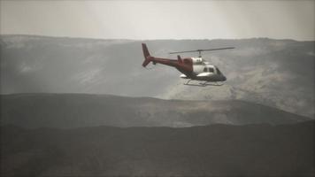 extreme slow motion vliegende helikopter in de buurt van bergen met mist foto