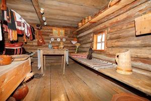 binnenruimte in het interieur van een oude Oekraïense landelijke hut met houten keukengerei en geborduurde kleding. 10.09.21. kiev. Oekraïne. foto