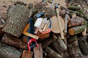 twee assen in stronken met houtbewerkingshulpmiddelen achtergrond gehakt brandhout. foto