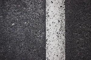asfaltweg met witte streeptextuur foto