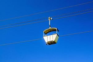 kabelbaan op touw van kabelbaan, blauwe heldere hemelachtergrond in zonnige zomerdag foto