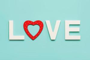 fijne Valentijnsdag. het woord liefde in wit houten met een rood hart. Valentijnsdag viering concept foto