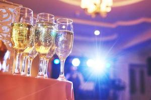 veel wijnglazen in blauw licht met een koele heerlijke champagne of witte wijn aan de bar foto