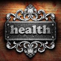 gezondheidswoord van ijzer op houten achtergrond foto