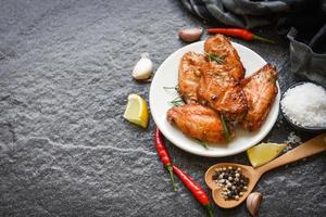 gebakken kippenvleugels met saus kruiden en specerijen koken thai aziatisch eten rozemarijn kip gegrild. foto