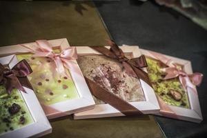 diverse chocolaatjes verpakt als cadeautjes met linten foto