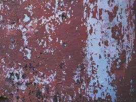 oude grunge cement muur achtergrond met gebarsten patroon en rode afbladderende verf foto