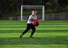 kleine jongen die met de bal speelt foto