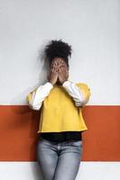 zwarte vrouw in trendy kleding die het gezicht bedekt foto