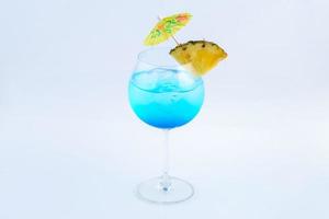 blauwe hawaii frisdrank met ananas. drank voor de zomer met witte achtergrond. foto