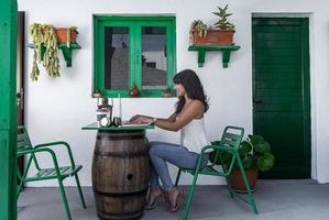 vrouwelijke freelancer die laptop op terras gebruikt foto