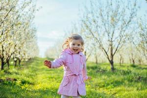 het kleine meisje dat in de lente zonnige dag loopt. kunstverwerking en foto