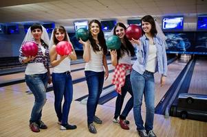 groep van zes meisjes met bowlingballen op vrijgezellenfeest op bowlingclub. foto