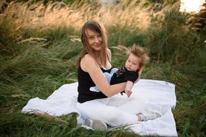 mama en baby knuffelen op een plaid foto