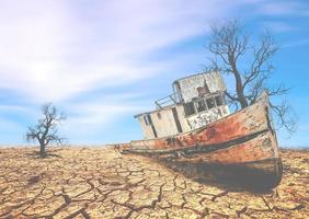 boten op een onvruchtbaar land. een schip op een gebroken land. het concept van droogte, opwarming van de aarde en het milieu. foto