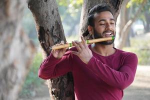 een man bespeelt het muziekinstrument fluit foto