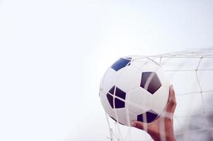 het bijgesneden beeld van sporters die de bal en het voetbalveld vangen. sport-beeld concept. foto