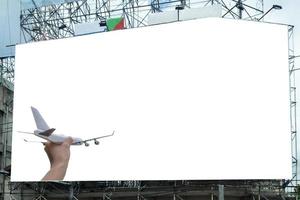 vliegtuig bij de hand met wit groot reclamebord adverteren foto