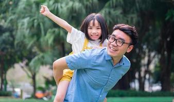 afbeelding van Aziatische vader en dochter die samen spelen in het park foto