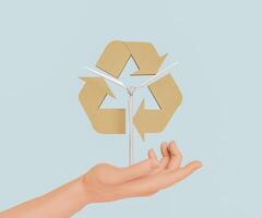 hand met een windturbine met het recyclingsymbool foto