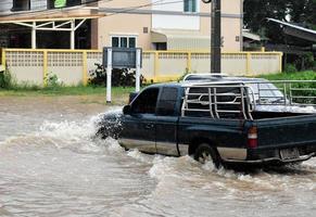 pick-up auto en voertuig in overstromingswater, autoverzekering en gevaarlijke situatie concept. foto