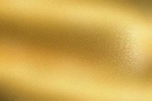 gloeiende gouden golf metalen wand, abstracte textuur achtergrond foto