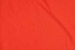 textuur van oranje sporttrui, shirtachtergrond foto