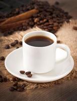 close-up weergave van een kopje koffie, bruine suiker en koffiebonen foto