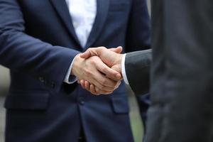 zakenmensen die handen schudden na succesvolle onderhandelingen foto