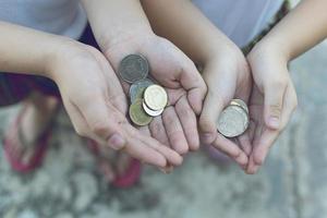 munt in de hand van kinderen. zakelijk en financieel concept foto