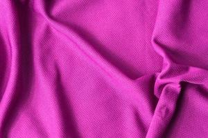 roze stof getextureerde achtergrond. sport roze kleding stof jersey structuur. foto