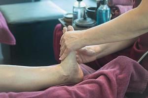 vrouw die voetmassage krijgt van masseuse foto