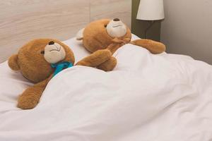 teddybeer liggend in het bed foto