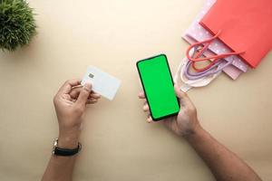 man hand met creditcard en met behulp van slimme telefoon online winkelen foto