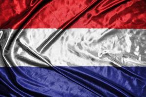 nederland doek vlag satijnen vlag wuivende stof textuur van de vlag foto