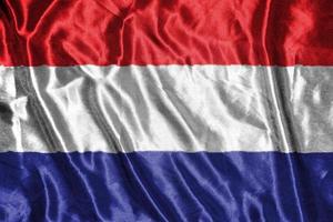 nederland doek vlag satijnen vlag wuivende stof textuur van de vlag foto