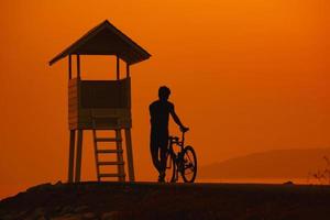 silhouet van een fietser op zonsondergang in thailand. foto