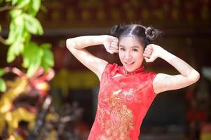 Aziatische mooie vrouw gefotografeerd in Chinese klederdracht voor het Chinese Nieuwjaarsevenement foto