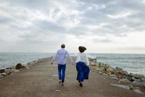 een liefdevol stel, man en vrouw die van de zomervakantie genieten op een tropisch paradijsstrand met helder zee-oceaanwater en landschap foto