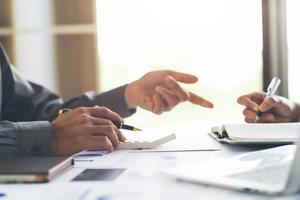 groep van twee zakenmensen bezig met het bespreken van financiële aangelegenheden tijdens vergadering foto