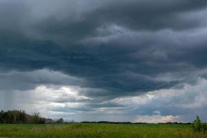 naderende onweerswolken boven een canola-veld, saskatchewan, canada. foto
