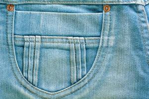 de blauwe spijkerbroek of blauwe denim schone textuur. foto