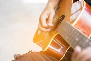 close-up iemands hand gitaar spelen. foto