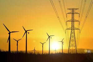 silhouetten van windturbines worden gebruikt om in de avonduren elektriciteit op te wekken in de velden. foto